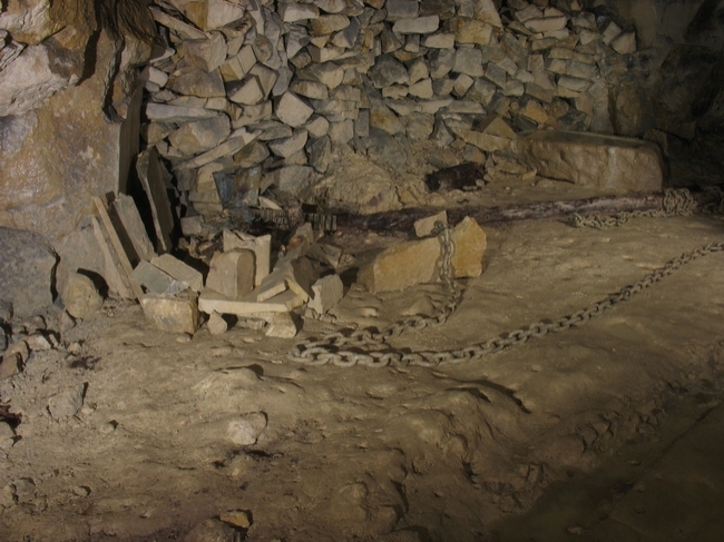 Relics including chain, partly worked blocks and a water trough