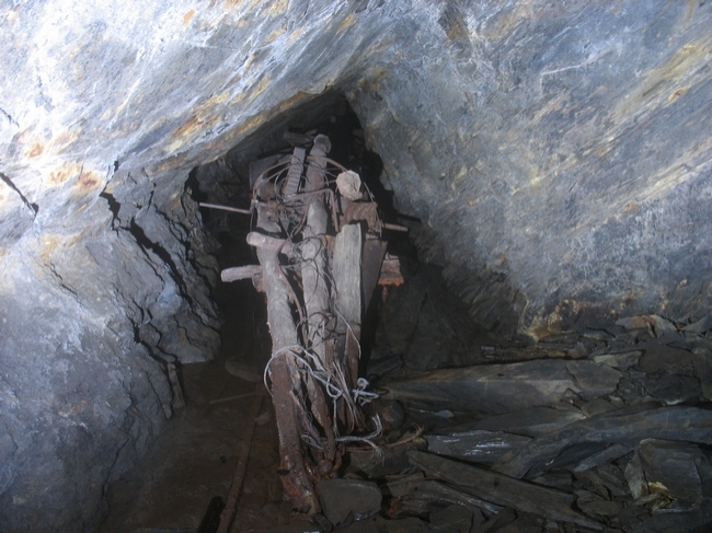 The remains of a dismantled derrick crane in the nearby level