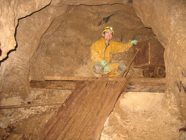 Neil poses beside a full tub of barites rich material waiting to be tipped down the chute into other tubs that were taken to the surface.