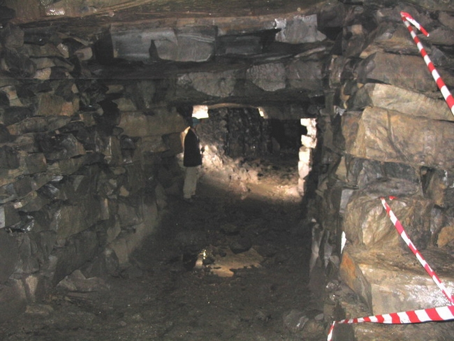 Looking down a main passage. The red and white tape is presumably a safety measure.