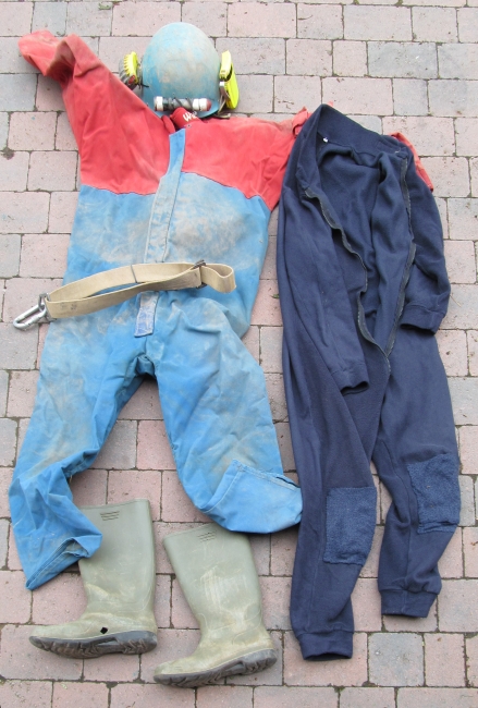 The minimum for caving: oversuit, undersuit, helmet, light and boots. Belt is useful